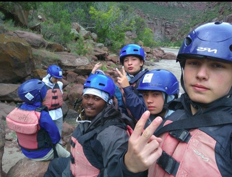 Students prepare for a whitewater rafting expedition during an Outward Bound USA leadership experience, building teamwork, resilience, and confidence in a canyon environment.